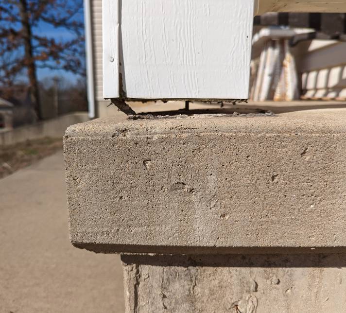 a concrete pillar with a white frame