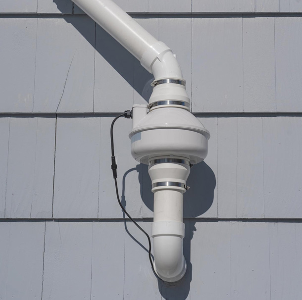 White pipe system on building exterior