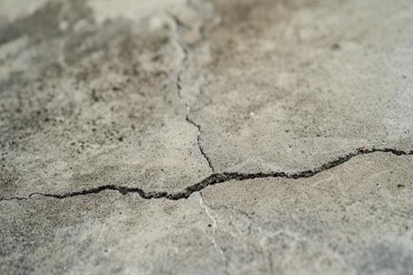 Cracked concrete surface with texture.