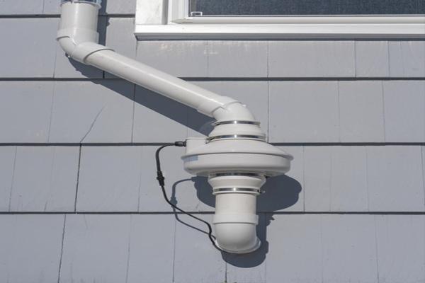 White ventilation pipe on wall