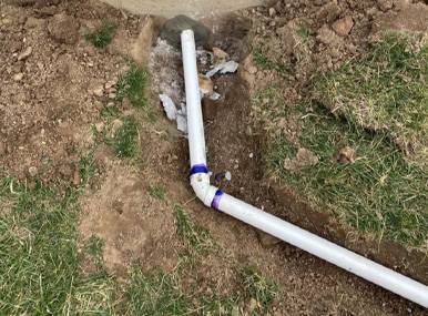 Sump pump discharge pipe outside home
