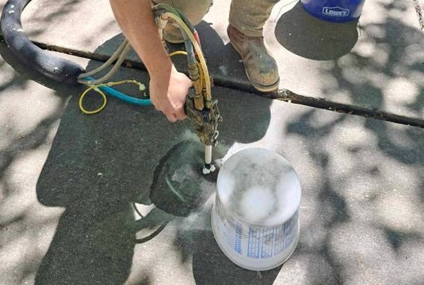 Worker using equipment on concrete